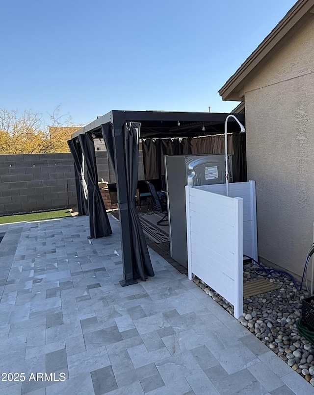 view of patio featuring fence