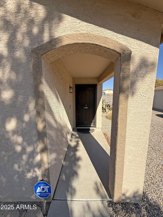 entrance to property featuring stucco siding