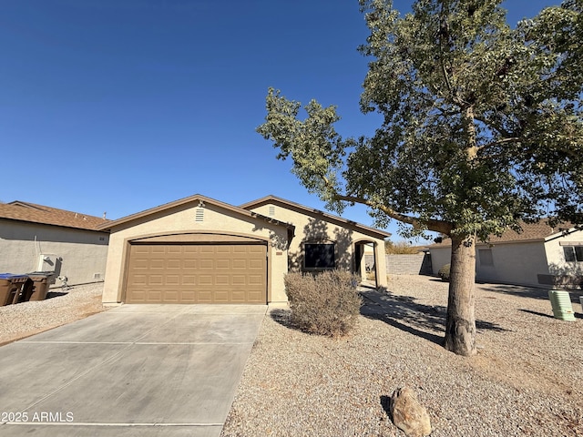 view of front facade with concrete driveway, an attached garage, and stucco siding