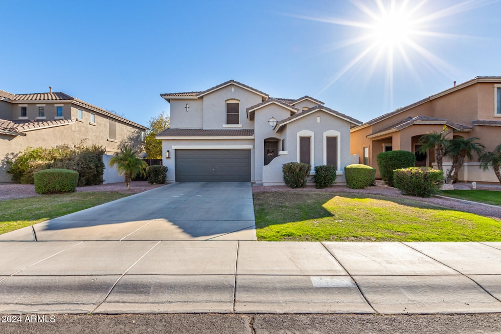 view of front of house featuring a garage and a front yard