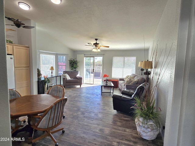 dining room featuring ceiling fan, dark wood-type flooring, and lofted ceiling