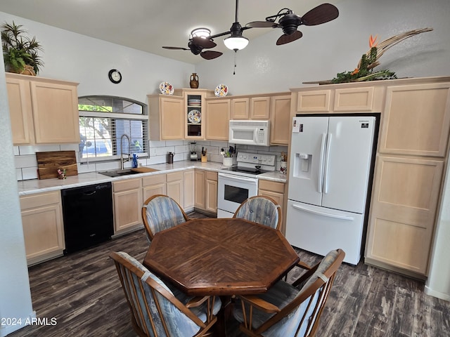 kitchen with decorative backsplash, light brown cabinetry, white appliances, dark wood-type flooring, and sink