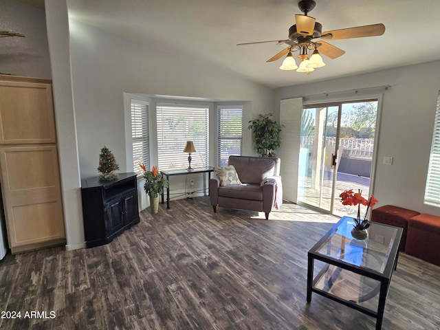 living room featuring vaulted ceiling, ceiling fan, and dark wood-type flooring