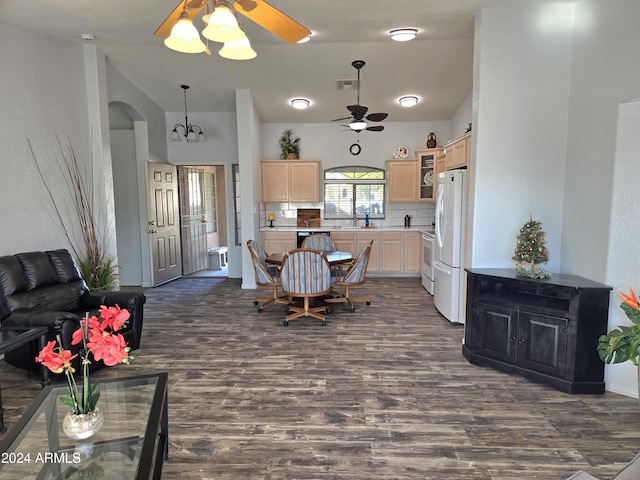 interior space with ceiling fan with notable chandelier, dark wood-type flooring, and sink