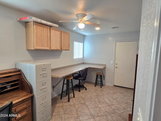 office featuring ceiling fan and a textured ceiling