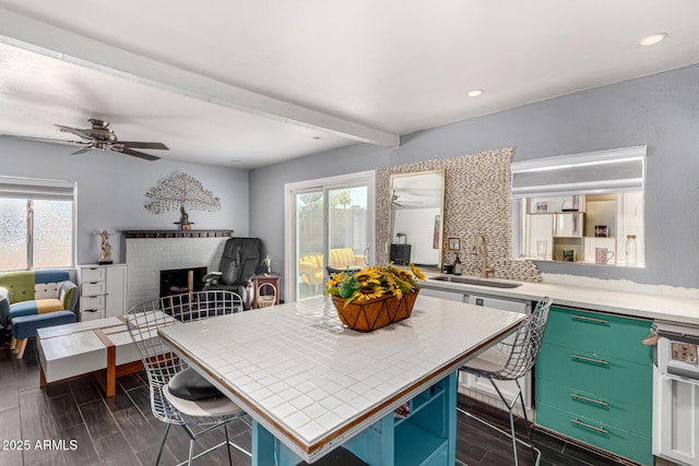 2802 E Virginia Ave, Phoenix, AZ 85008 - kitchen with a ceiling fan, plenty of natural light, a brick fireplace, beam ceiling, and recessed lighting