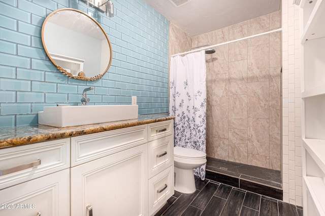 2802 E Virginia Ave, Phoenix, AZ 85008 - full bathroom with vanity, tiled shower, wood tiled floors, and tasteful backsplash