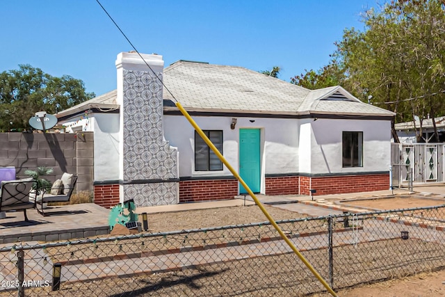 2802 E Virginia Ave, Phoenix, AZ 85008 - view of front facade with stucco siding, a chimney, roof with shingles, and brick siding