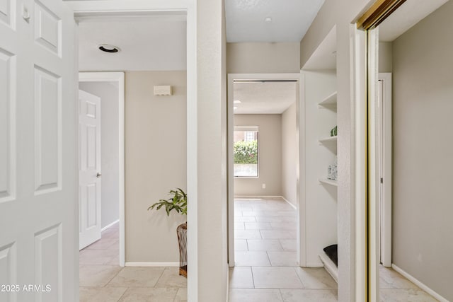 corridor with light tile patterned floors