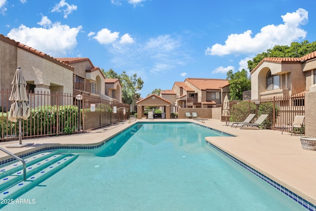 view of swimming pool featuring a gazebo and a patio area