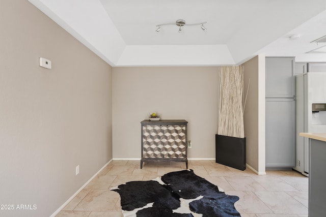 sitting room with light tile patterned floors and a tray ceiling