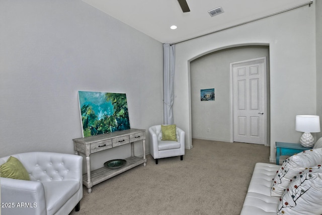 living room with light carpet and ceiling fan