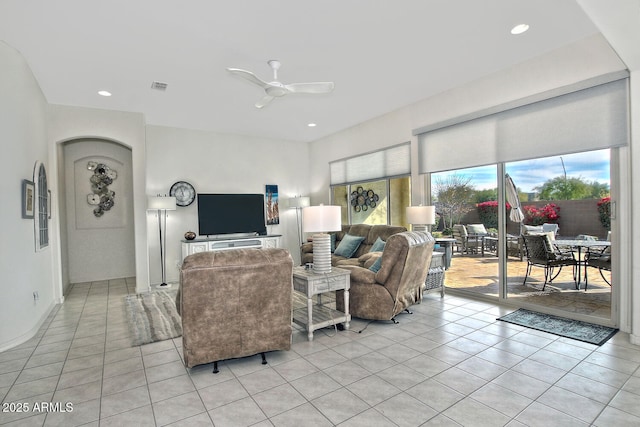 tiled living room with ceiling fan