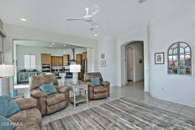 tiled living room with ceiling fan