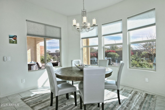 dining space featuring a notable chandelier and light tile patterned flooring