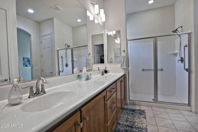 bathroom featuring tile patterned flooring, vanity, and an enclosed shower