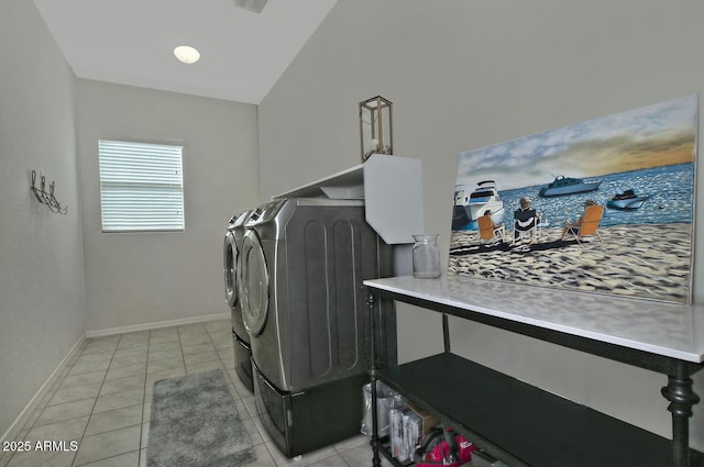 clothes washing area featuring washing machine and dryer and light tile patterned floors