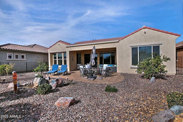 rear view of house featuring a patio area and an outdoor living space