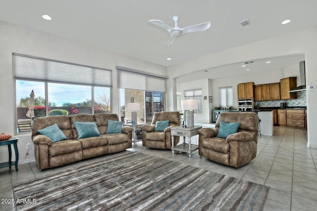 living room featuring ceiling fan and light tile patterned floors