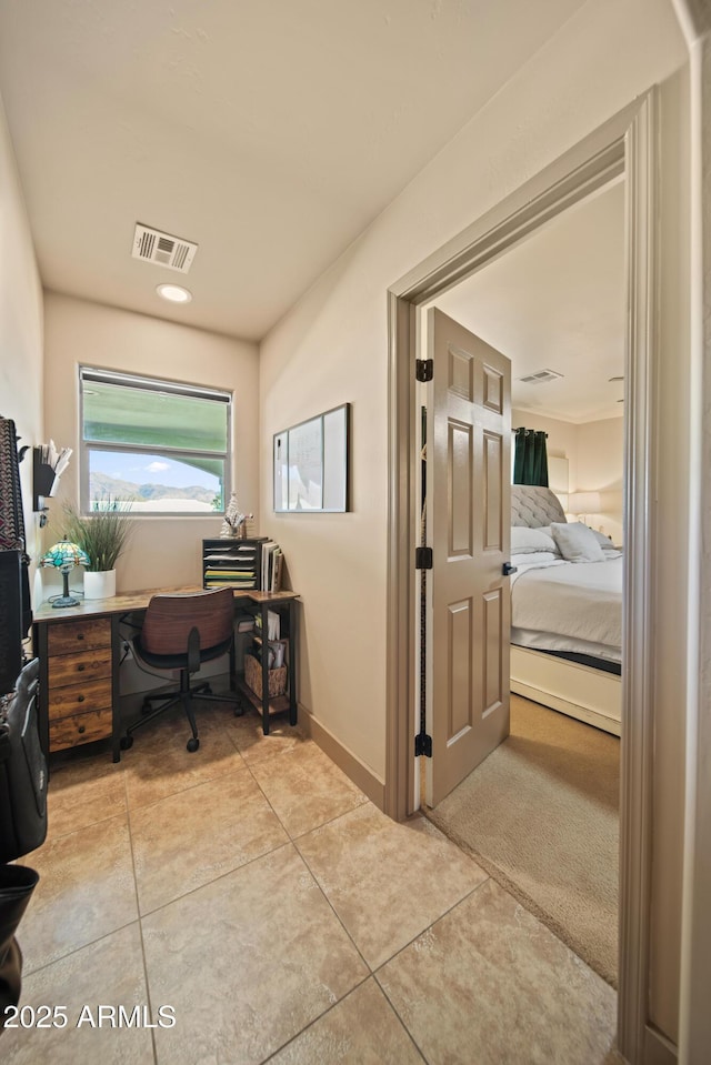 office space with light tile patterned floors, baseboards, and visible vents