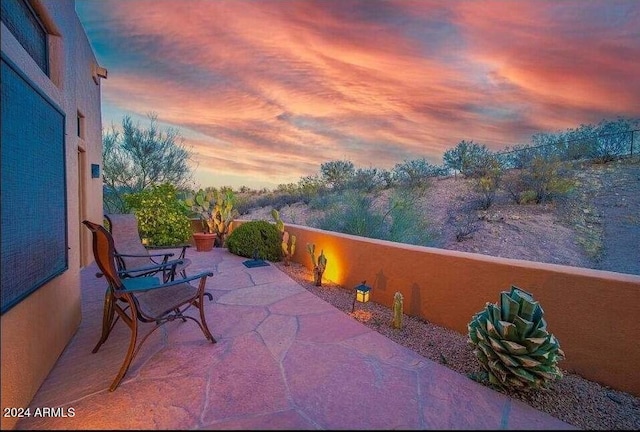 view of patio terrace at dusk