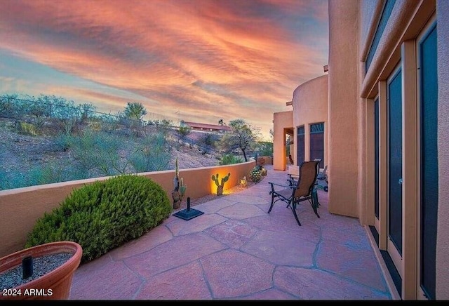 view of patio terrace at dusk