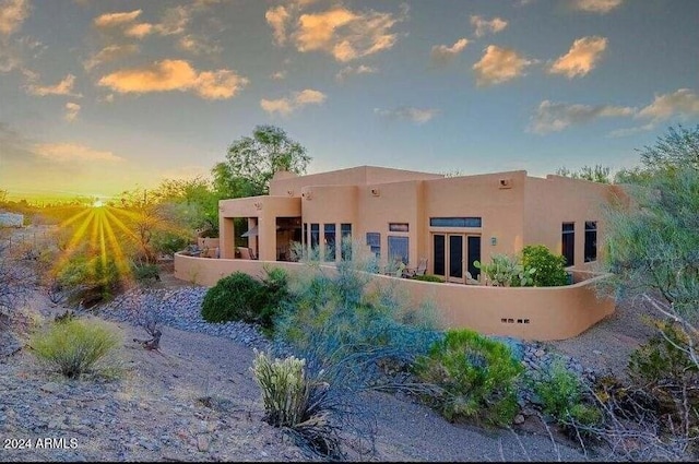 view of back house at dusk