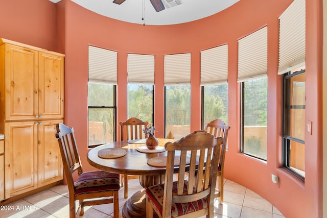 tiled dining area with ceiling fan