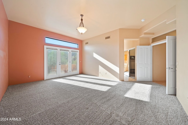 carpeted spare room with french doors