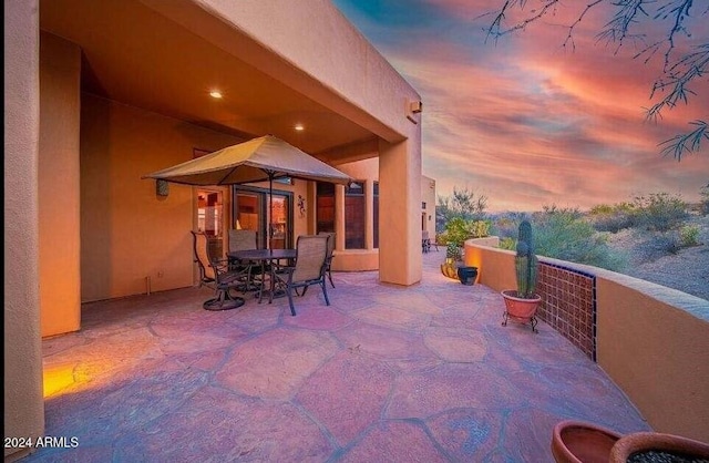 view of patio terrace at dusk