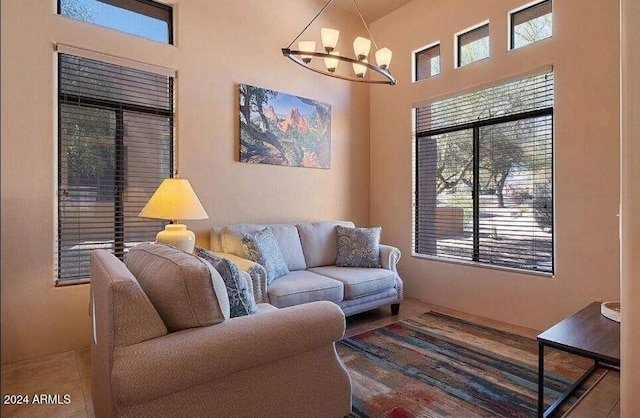 living room featuring a chandelier and tile patterned floors