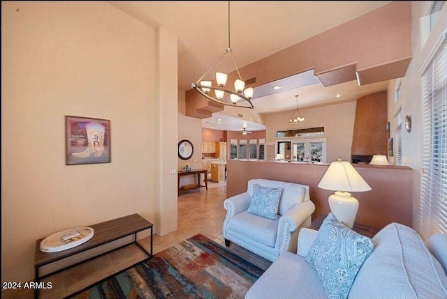 living room featuring tile patterned flooring, a high ceiling, and an inviting chandelier