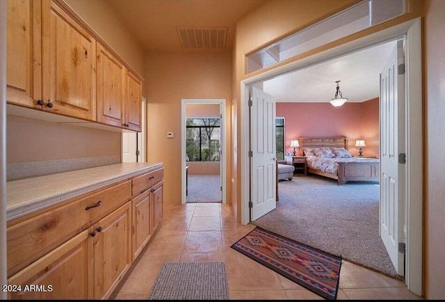 hallway with light colored carpet