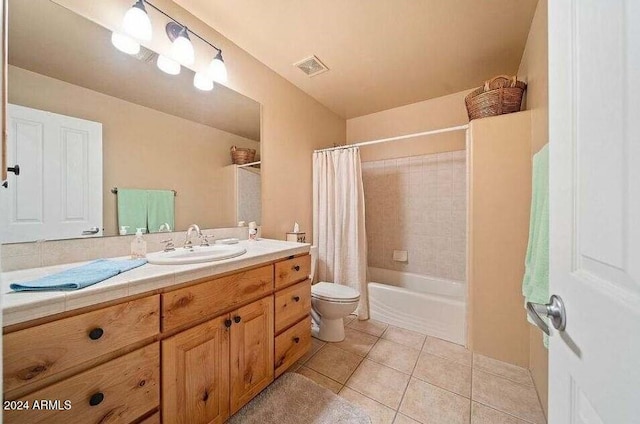 full bathroom featuring tile patterned floors, shower / tub combo with curtain, vanity, and toilet