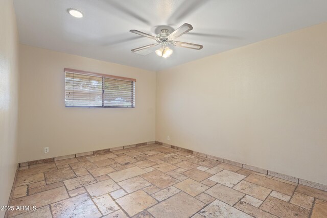 848 S Revolta Cir, Mesa, AZ 85208 - empty room featuring stone tile floors, ceiling fan, and baseboards
