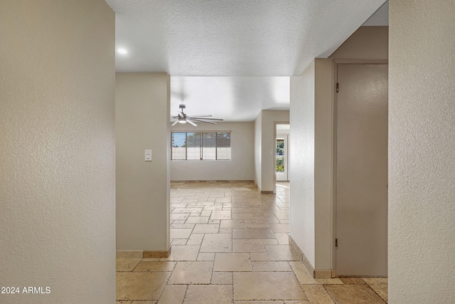 hallway with a textured ceiling