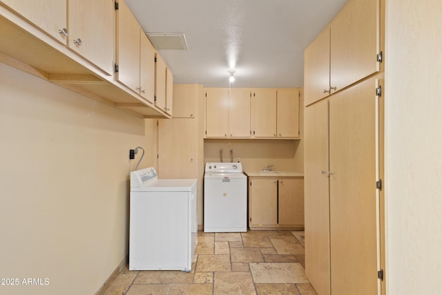848 S Revolta Cir, Mesa, AZ 85208 - clothes washing area featuring stone tile floors, cabinet space, baseboards, and washing machine and clothes dryer