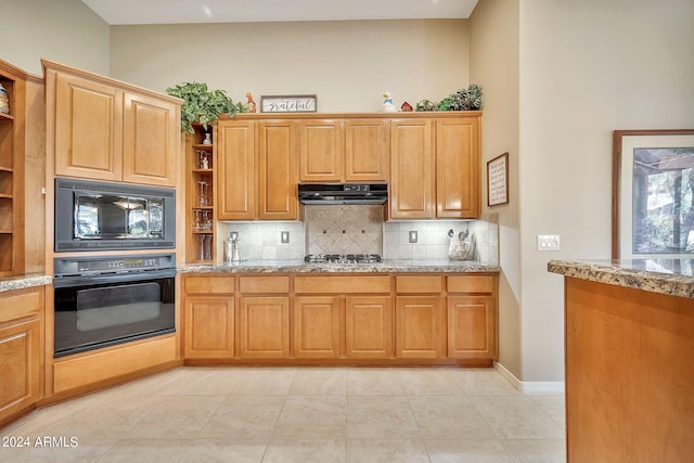 kitchen with light stone countertops, light tile patterned floors, decorative backsplash, and black appliances