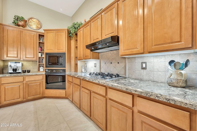 kitchen featuring lofted ceiling, backsplash, and black appliances