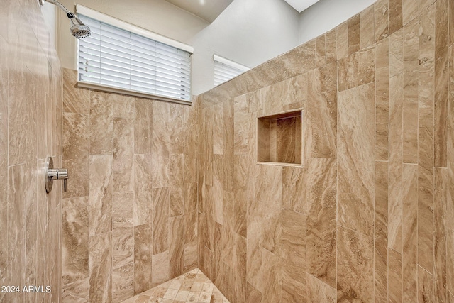 bathroom with a tile shower