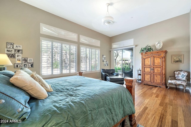 bedroom featuring light wood-type flooring, multiple windows, and ceiling fan