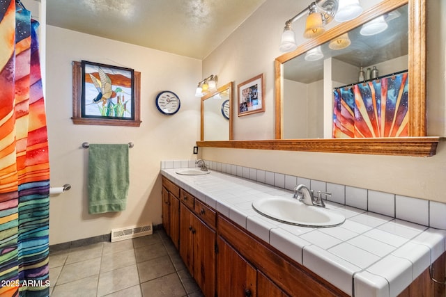 bathroom featuring tile patterned floors and vanity