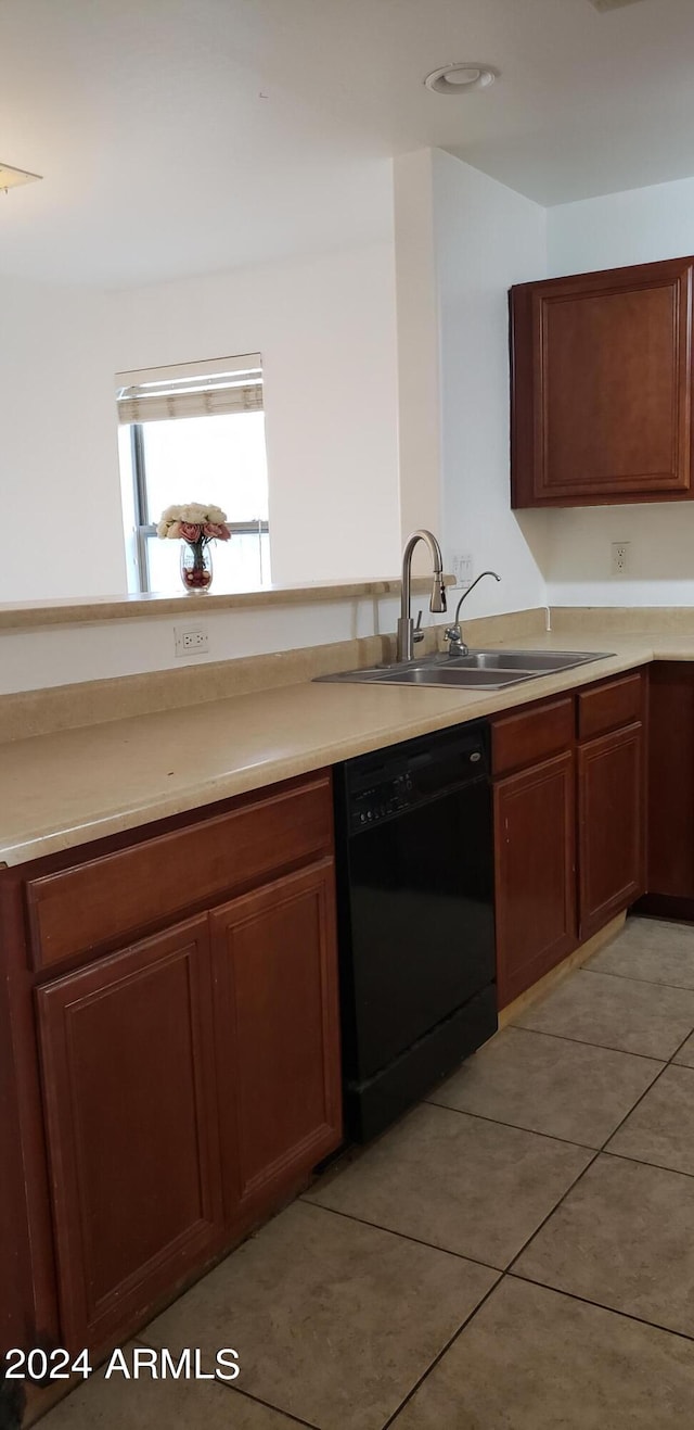 kitchen featuring light tile patterned floors, dishwasher, and sink