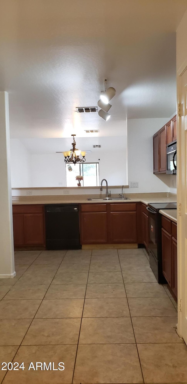 kitchen with light tile patterned floors, an inviting chandelier, sink, and black appliances