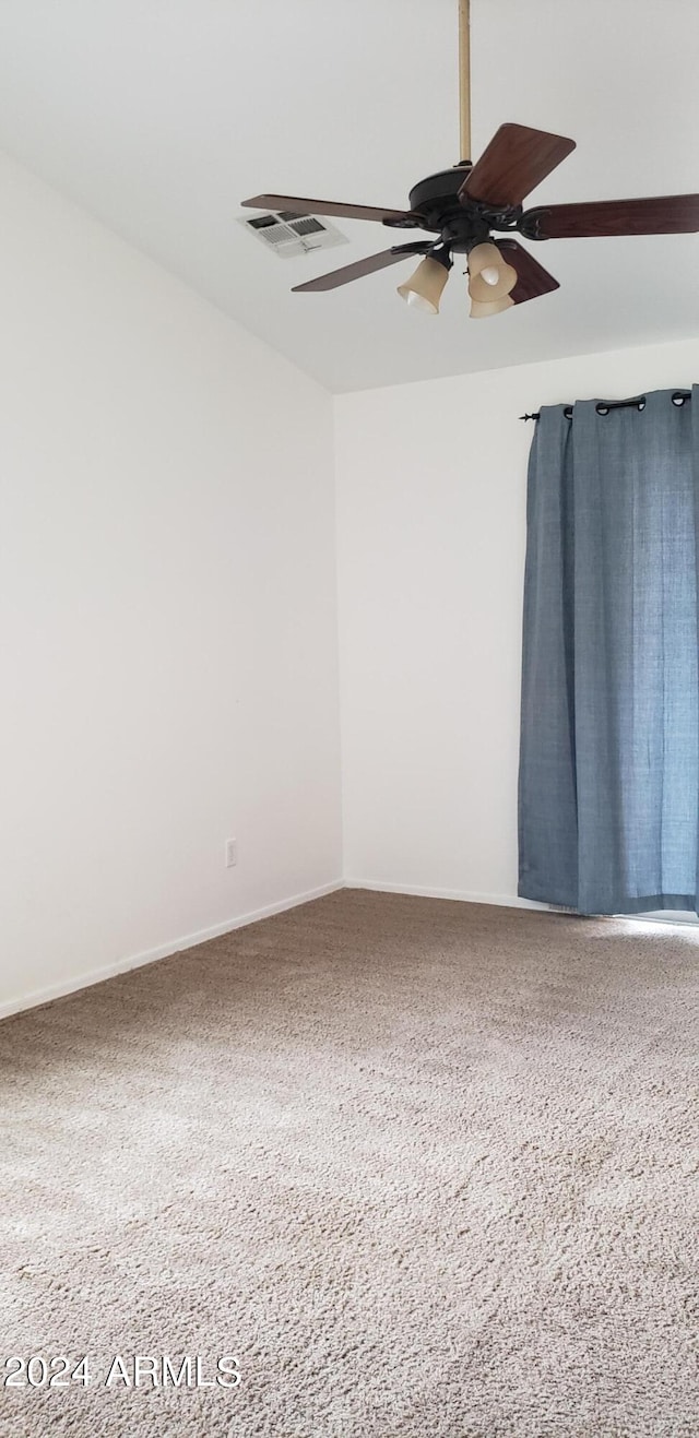 carpeted spare room with ceiling fan