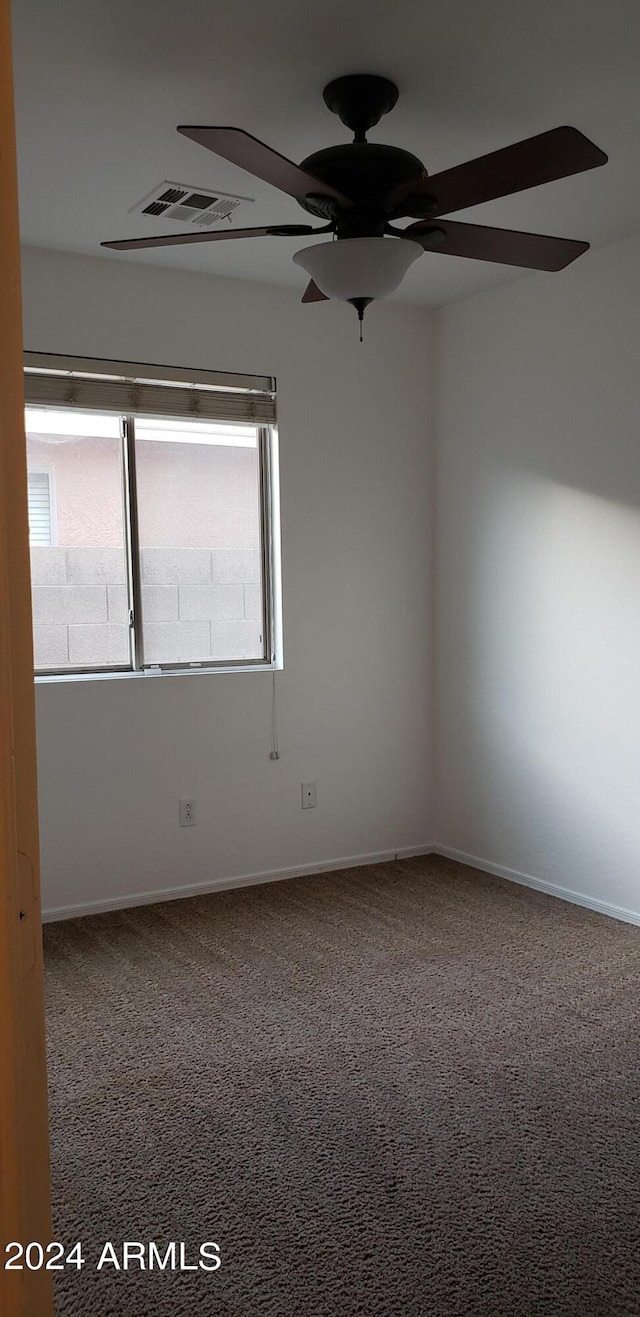 unfurnished room featuring carpet floors and ceiling fan