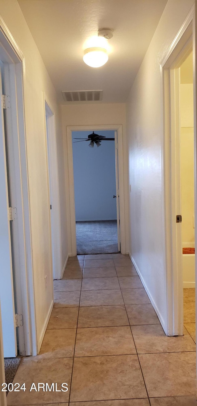 hallway featuring light tile patterned floors