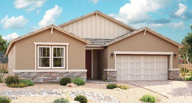 view of front of home featuring decorative driveway, an attached garage, stone siding, and stucco siding