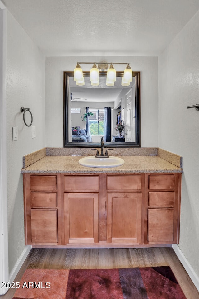3500 N Hayden Rd Unit 203, Scottsdale, AZ 85251 - bathroom with wood finished floors, vanity, and baseboards