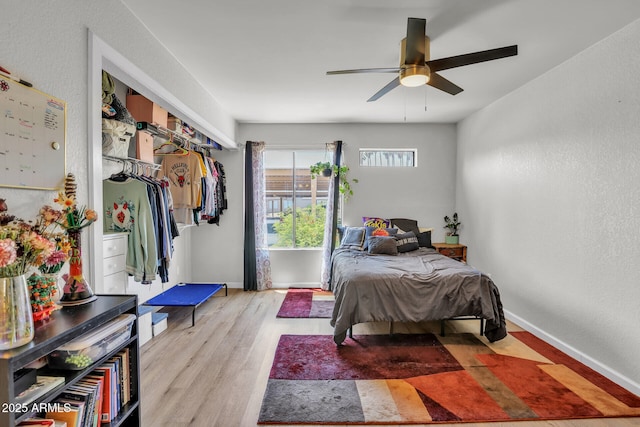 3500 N Hayden Rd Unit 203, Scottsdale, AZ 85251 - bedroom with wood finished floors, baseboards, a textured wall, and a ceiling fan